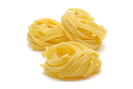 Italian pasta "tagliatelle" isolated on white background